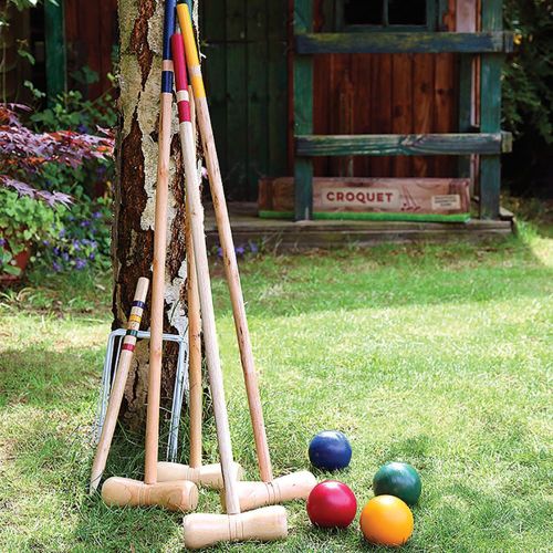 Classic wooden croquet set with mallets, balls, and hoops, perfect for family outdoor fun and gatherings. Suitable for ages 5+.