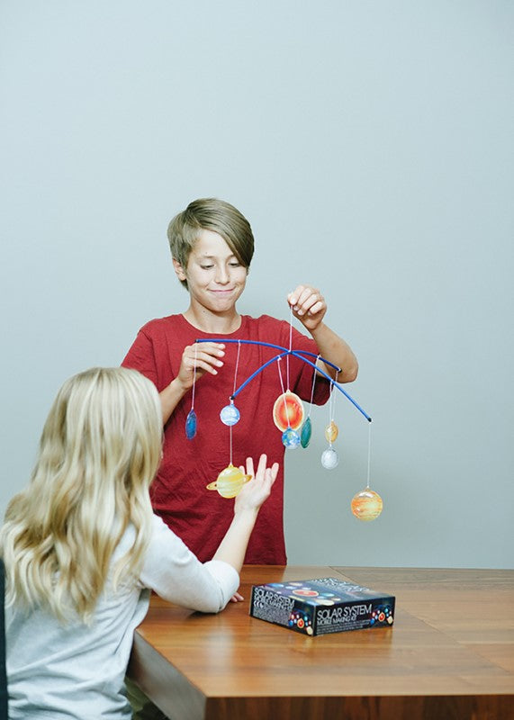 3D Solar System Mobile Making Kit by 4M, featuring a glowing, revolving model for fun STEM learning and creativity.