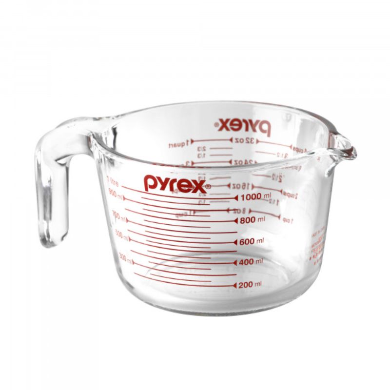 Clear Pyrex 4 Cup Measuring Jug (1L) with red measurement markings, ergonomic handle, and pouring spout for precise, mess-free measuring.