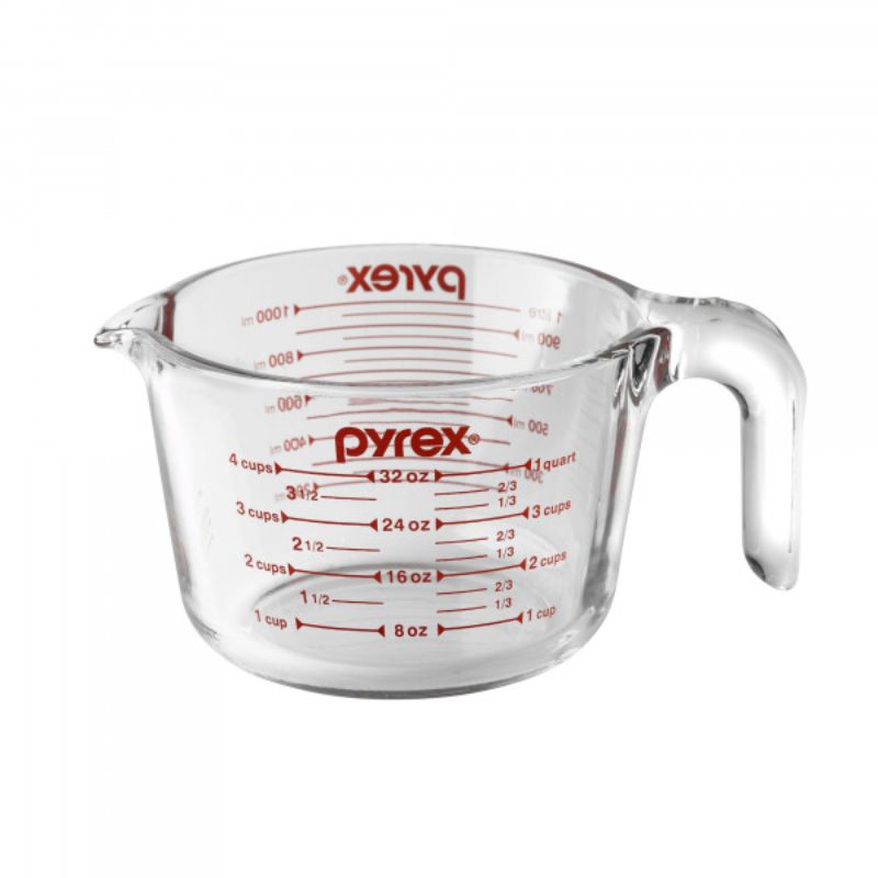 Clear Pyrex 4 Cup Measuring Jug with ergonomic handle and red measurement markers, perfect for precise liquid measuring and pouring.