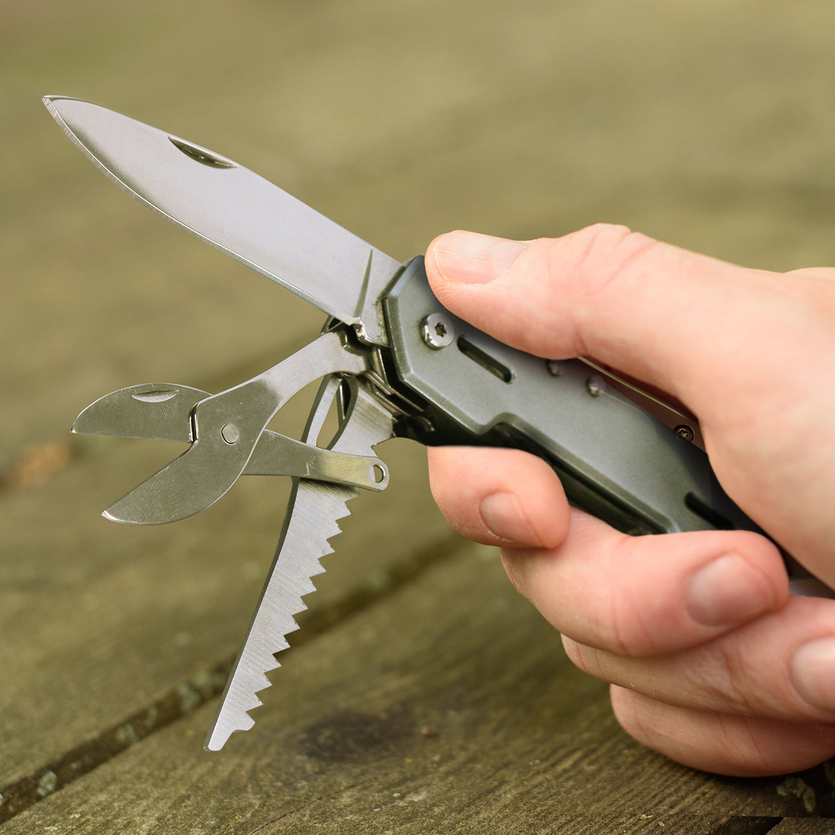 Versatile silver multi-tool with 9 functions, durable aluminum, includes carabiner and comes in a stylish gift box.