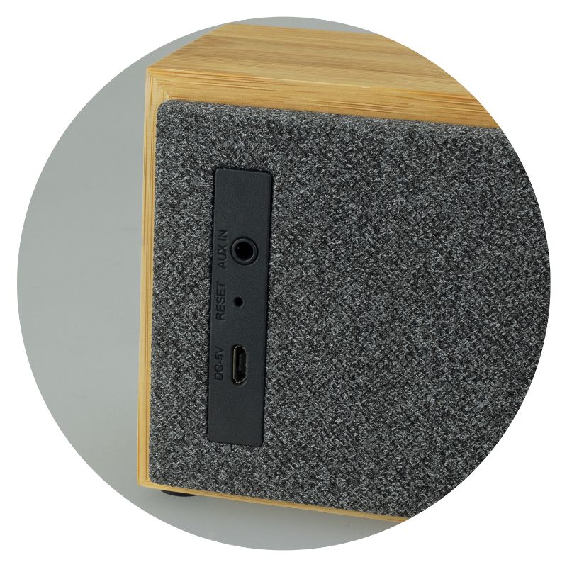 Bluetooth speaker in natural bamboo finish with polyester front, offering 10W power and 6-hour battery life.