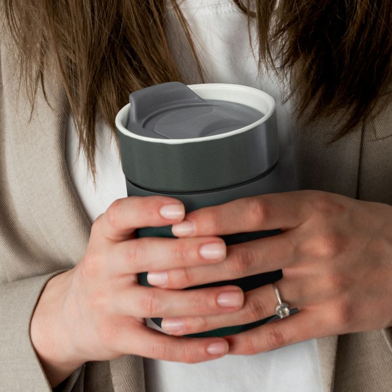 Three stylish 300ml charcoal ceramic coffee cups with silicone casings and slide-closure lids for hot beverages on the go.