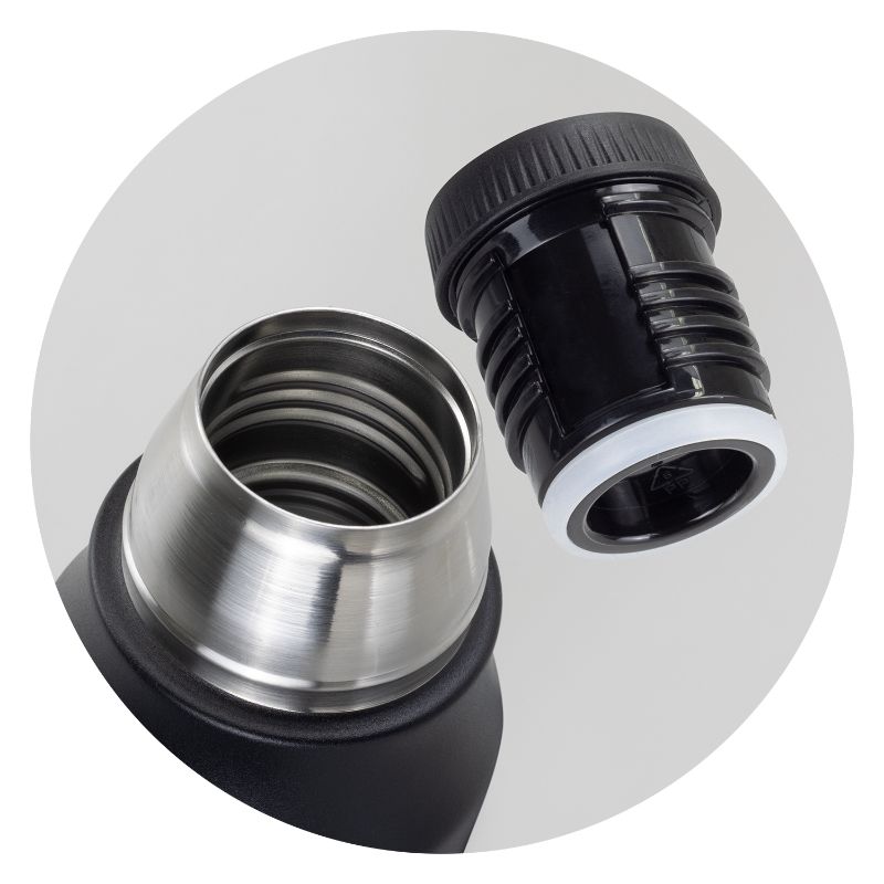 Black stainless steel Wayfarer flask with double-wall vacuum design, screw-on cup, and carry handle, packaged in a sleek gift box.