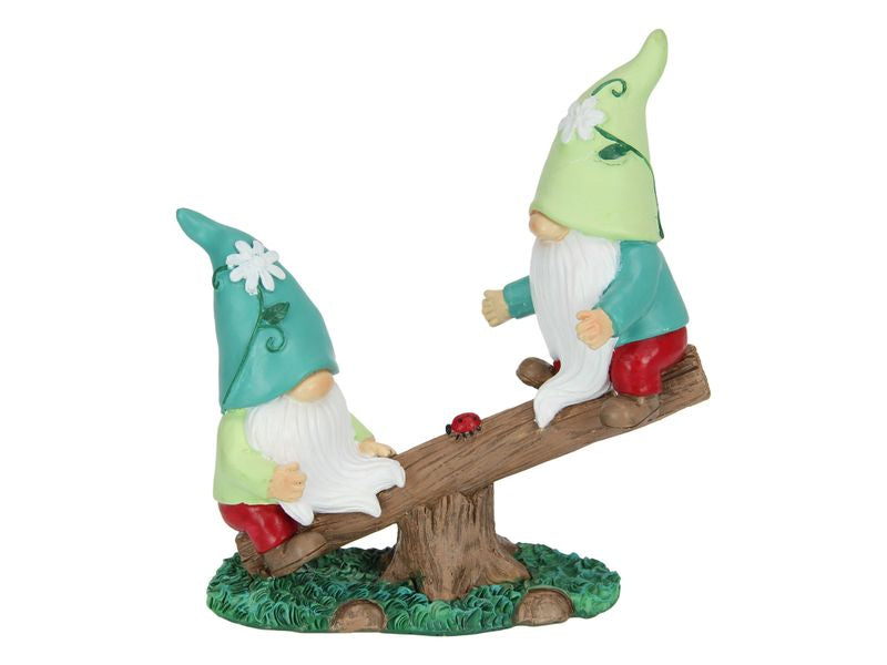 Twin gnomes happily balancing on a see-saw, perfect for adding festive charm to your holiday decor.