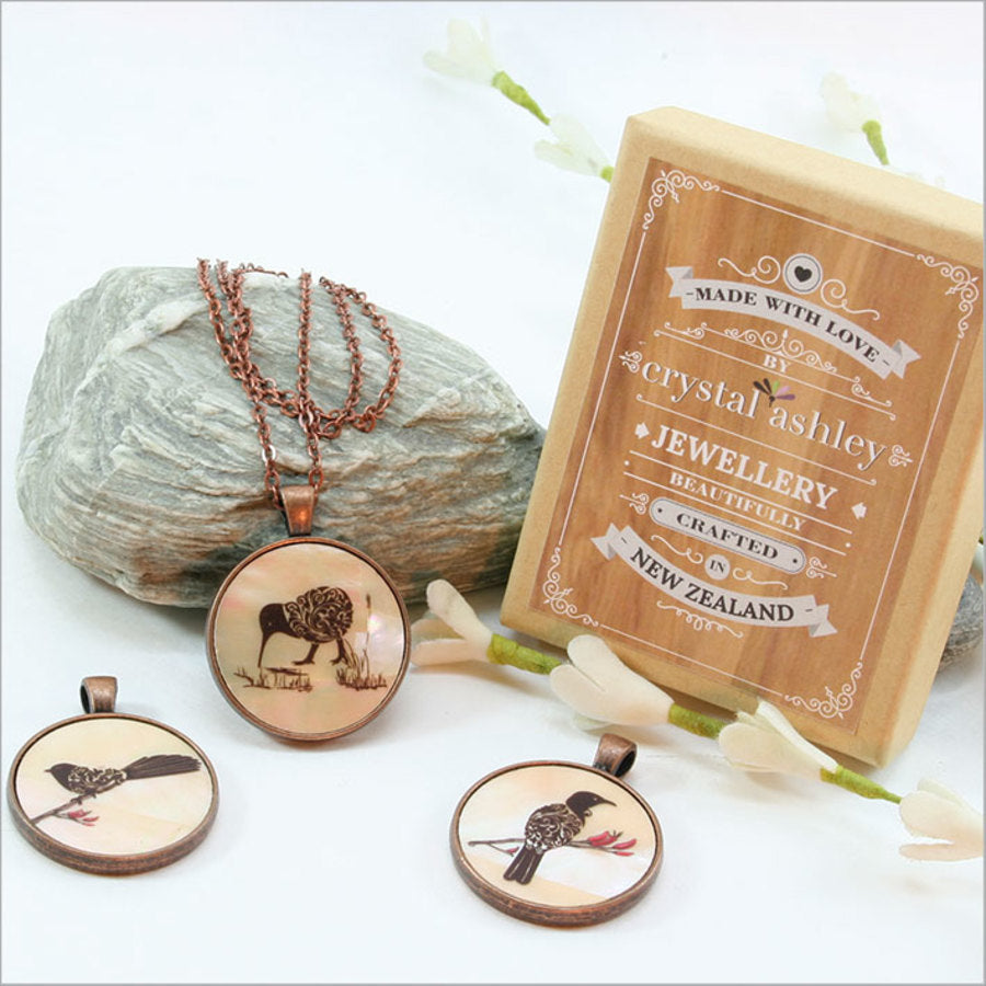 Circle pendant necklace featuring a filigree tui design on mother of pearl, with a 30mm pendant and 75cm adjustable chain.