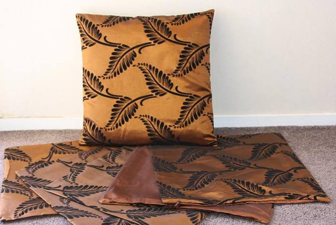 Set of 6 fern-patterned cushion covers in rich copper, crafted from satinee fabric with zip closure for easy care.