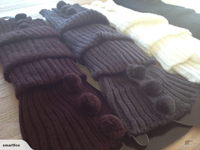 White cable knit leg warmers with pom-poms, 40cm long, soft and warm, ideal for winter fashion and gifting.