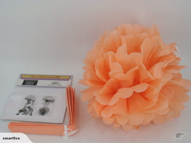 Light orange 30cm paper pom pom lanterns, 12 units perfect for decor at weddings, parties, and kids' rooms.