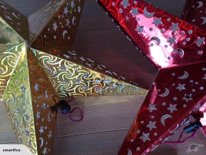Three vibrant red star lanterns, 45cm, designed to illuminate with patterns, perfect for parties or decor.