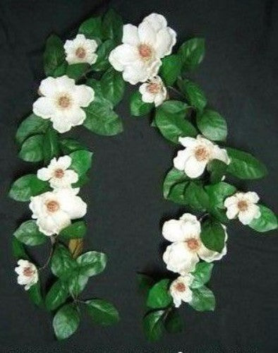 Lifelike 140cm Magnolia Garland with white flowers, perfect for versatile home decor and seasonal embellishments.