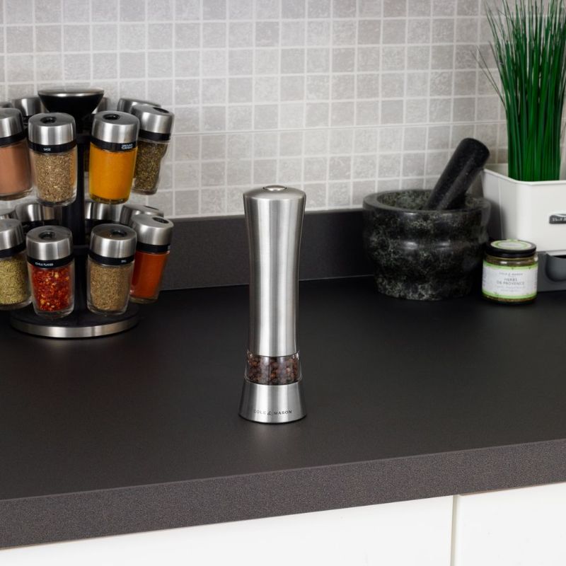 Electronic mill with brushed stainless steel body, one-handed operation, LED light, and adjustable grind for salt or pepper.