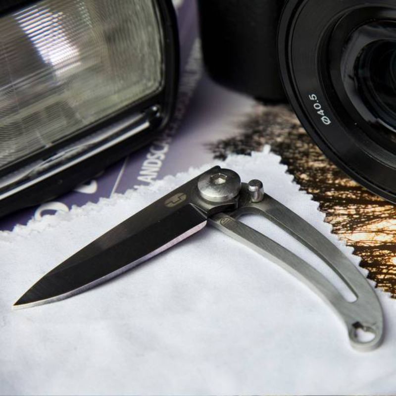 Compact stainless steel folding knife with keyring, weatherproof box, and safe blade locking mechanism.