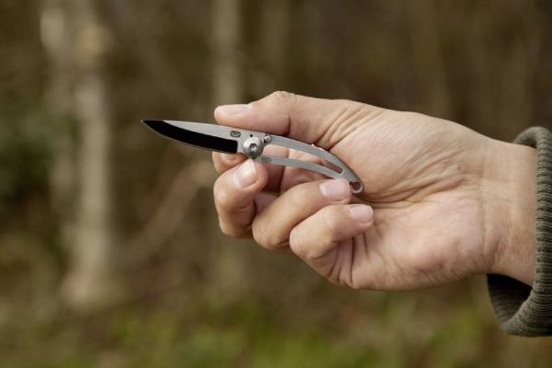 Compact folding knife with stainless steel blade, key ring safety, and weatherproof box; ideal for everyday carry.
