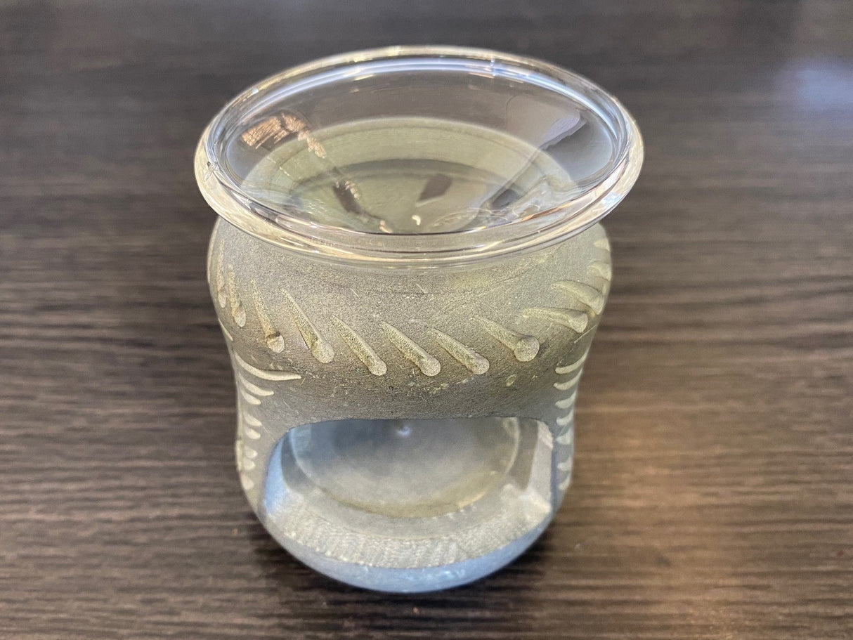 Soapstone aroma therapy oil burner with fine carvings, perfect for creating a serene atmosphere with essential oils.