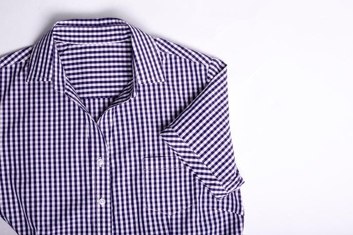 Vibrant purple short sleeve shirt for women, featuring a check pattern, open neck, and practical front pocket for style and comfort.