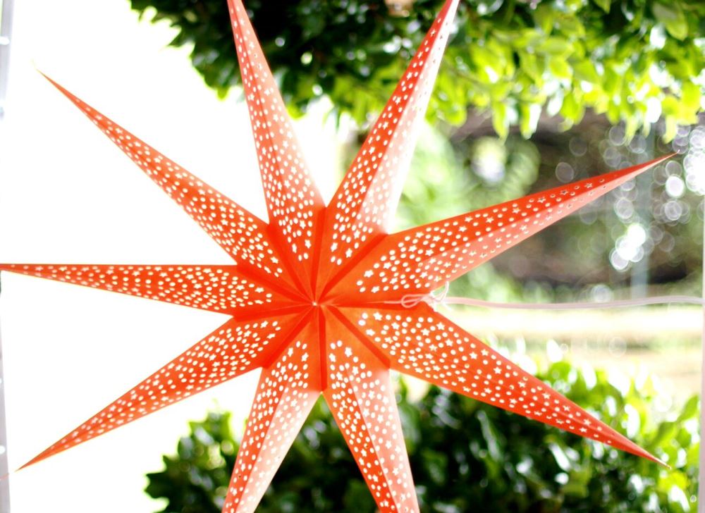 Vibrant orange star lantern lamp shade, 90cm, handmade from thick paper, perfect for adding warmth to any space.