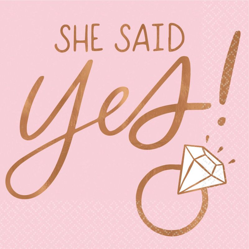 Blush beverage napkins with 'She Said Yes' in gold, ideal for weddings and engagement parties, pack of 16 elegant napkins.