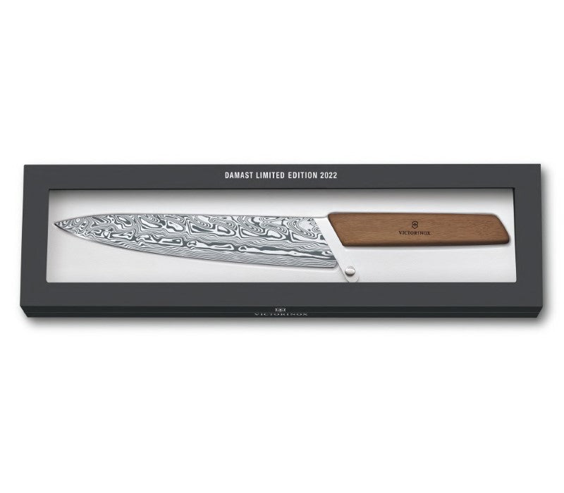 Victorinox limited edition carving knife with Damasteel blade and ergonomic walnut handle, showcasing unique 'Thor' design.