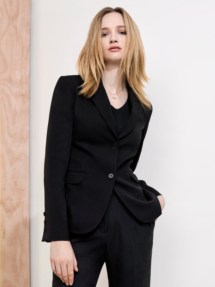 Navy mid-length jacket for women, featuring two buttons, front pockets, and a fully lined interior for stylish comfort.