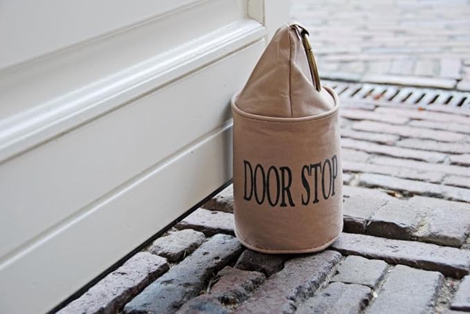 Stylish fabric doorstop bag with large metal ring, preventing door slamming and protecting floors, measuring 13 x 28 cm.