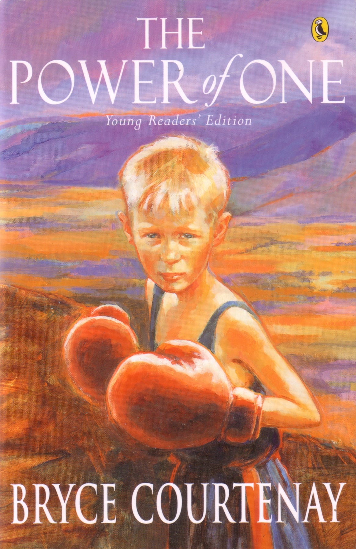 Cover of "The Power of One: Young Readers' Ed," showcasing a young boy, symbolizing resilience and courage in a divided society.
