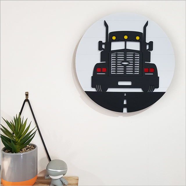 Round wall art featuring a big rig truck, crafted from ACM and acrylic, perfect for nursery or bedroom decor.