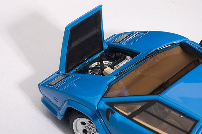 Diecast 1/43 Lamborghini Countach 5000S in blue, showcasing opening doors and detailed engine compartment for collectors.