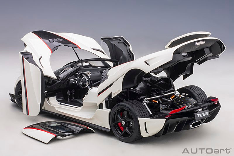 1/18 scale diecast model of a white Koenigsegg Regera with black carbon accents and red details, showcasing elegance and precision.