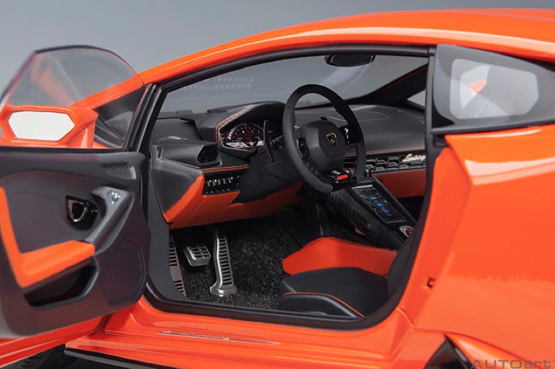Diecast model of Lamborghini Huracan Evo in vibrant orange, showcasing intricate details and luxury sports car design.