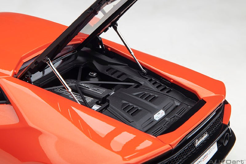 Diecast model of a 1/18 Lamborghini Huracan Evo in vibrant orange, showcasing meticulous details and luxury design.