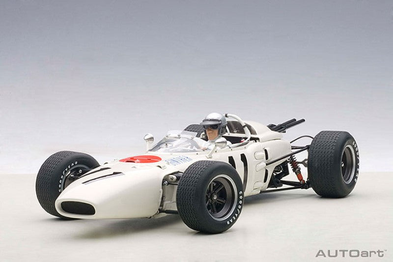 Diecast model of the '65 Honda RA272 #11, featuring intricate details, vibrant paint, and a driver figure for collectors.