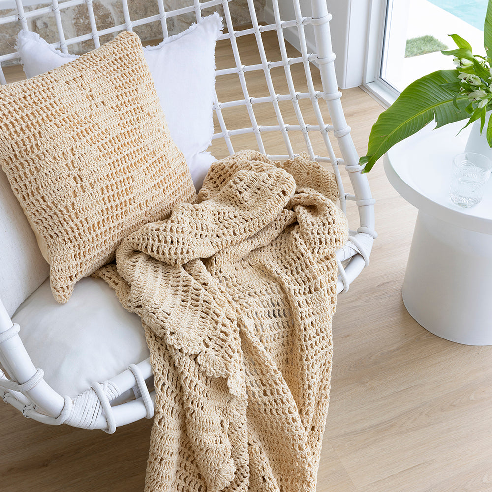 Hand-crocheted cotton throw in custard with floral motif, perfect for adding warmth and style to your home decor.