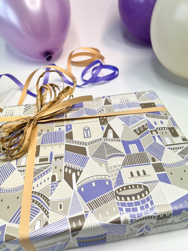 Taupe and purple wrapping paper featuring whimsical castle motifs, perfect for any celebration. 600mm x 40m, durable 80gsm.