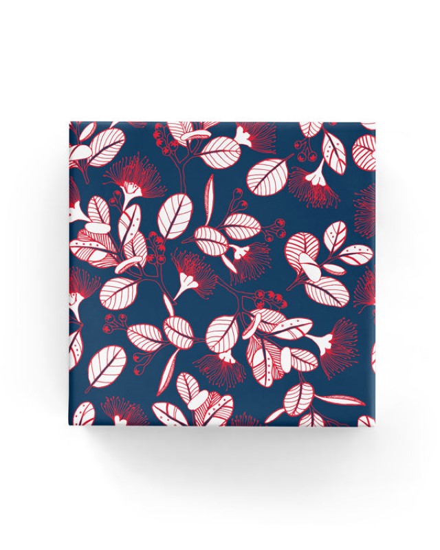 Wrapping paper featuring navy red pohutukawa flowers, 600mm wide and 40m long, ideal for elegant gift-wrapping.