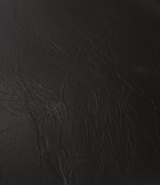 Black leather armchair with cow skin, inspired by saddlery, featuring a solid timber frame for comfort and durability.