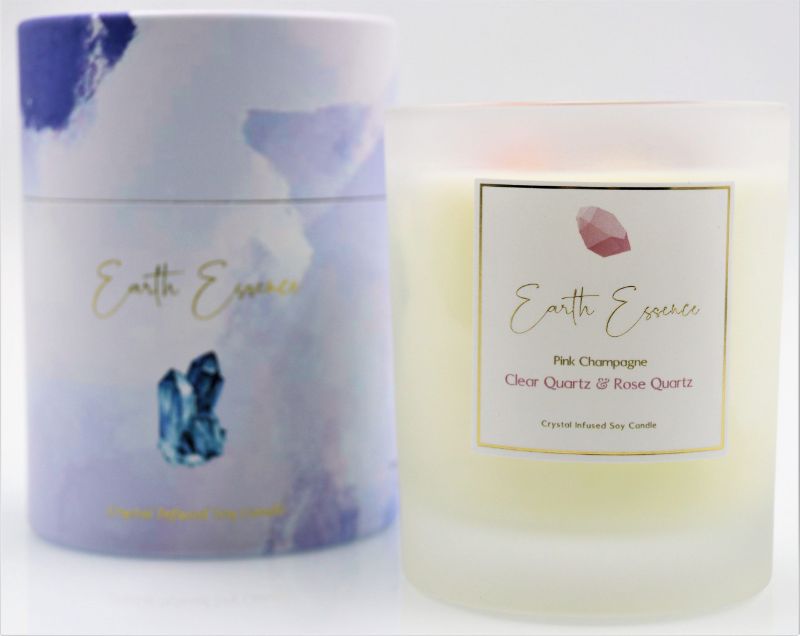 Soy wax candle in crystal pink, adorned with Rose Quartz, Clear Quartz, and dried Rose Petals; 40-hour burn time.
