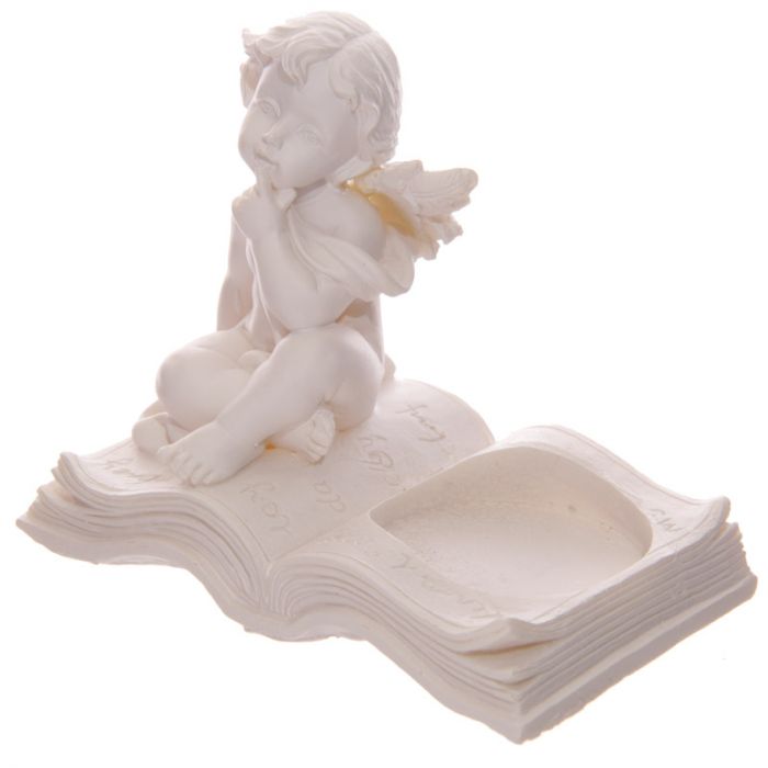 Set of 4 cherub tea light candle holders on books, adding charm and elegance to any decor with a cozy glow.