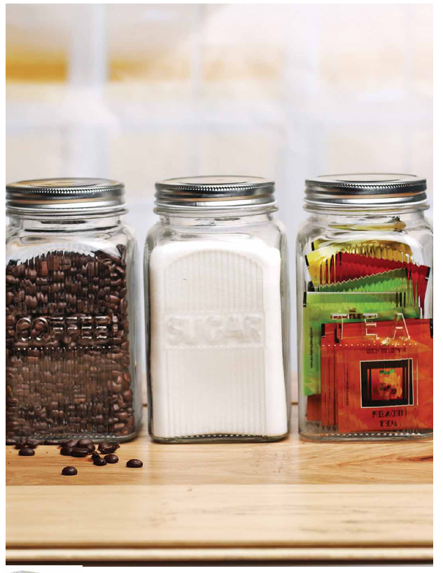 Elegant ribber glass canisters with metal lids, perfect for storing coffee, sugar, and tea on your kitchen bench.