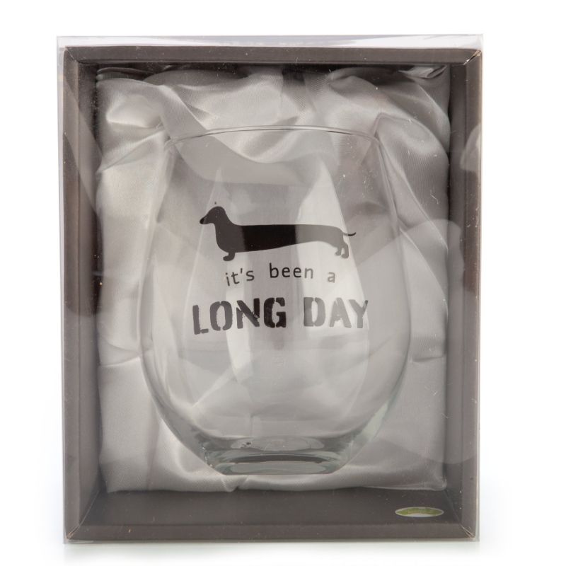 Hand-blown stemless wine glass featuring a dachshund silhouette and pun "It's been a long day," perfect for dog lovers.