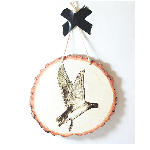 Wood slice wall art featuring a flying duck, crafted from eco-friendly pine veneer, perfect for unique home decor.