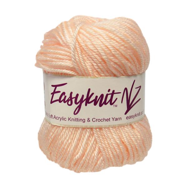 Soft baby peach 4-ply yarn in a 50g ball, perfect for cozy baby projects and gifts, ideal for all skill levels.