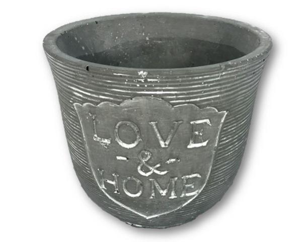 Round cast stone planter with 'Love & Home' design, ribbed finish, rubber feet, ideal for displaying house plants without drainage.