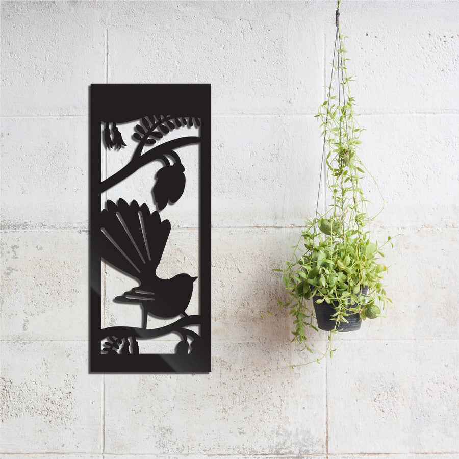 Black wall art featuring a Fantail bird surrounded by Kowhai flowers, celebrating Kiwiana and New Zealand's natural beauty.