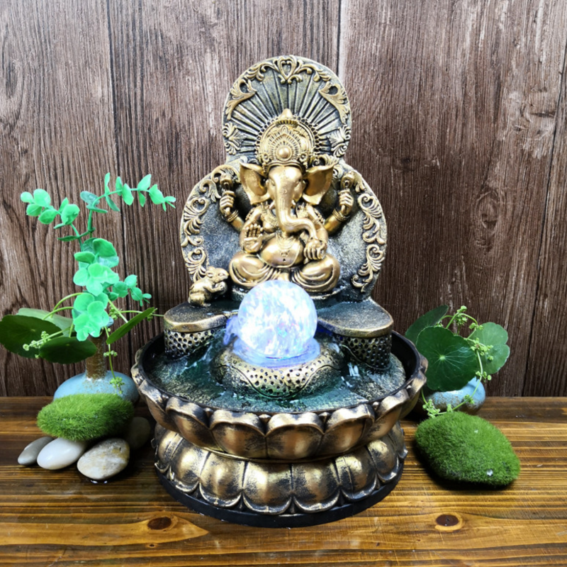 Gold Ganesh water feature with rolling ball, multi-coloured lights, 21x21x30cm, promotes tranquility and prosperity.