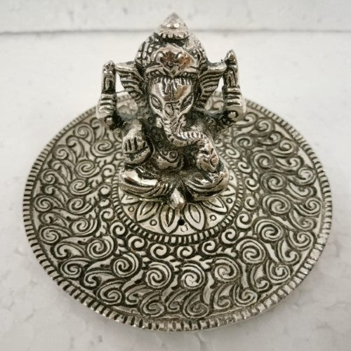 White metal round incense holder featuring intricate Ganesha designs, ideal for enhancing spiritual spaces.
