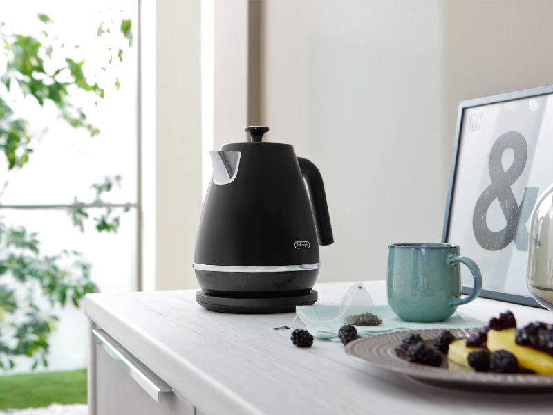Black DeLonghi Distinta Moments Kettle with matte finish, 1.7L capacity, swivel base, and safety features for stylish brewing.