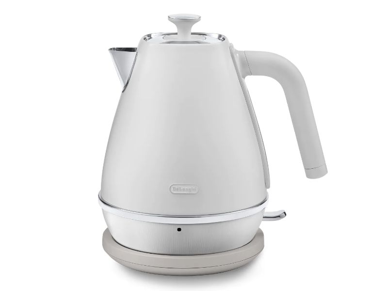 DeLonghi Distinta Moments Kettle in white with sleek metallic finish, 1.7L capacity, and 360° swivel base for cordless use.