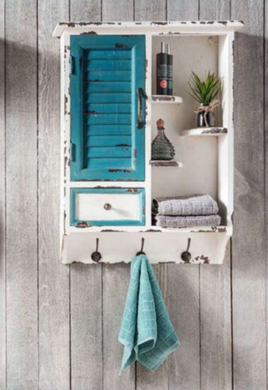 Wooden organizer with distressed finish, metal handles, and coat hooks; perfect for stylish storage in any space.