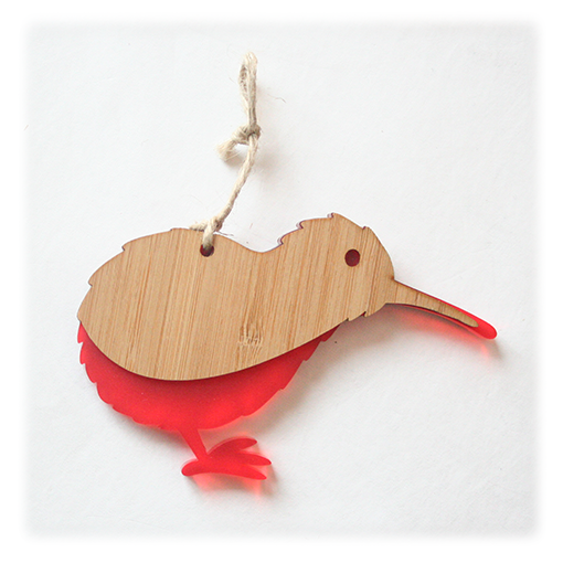 Vibrant red Kiwi Ornament made from bamboo and satin acrylic, perfect for holiday decor or as a thoughtful gift.